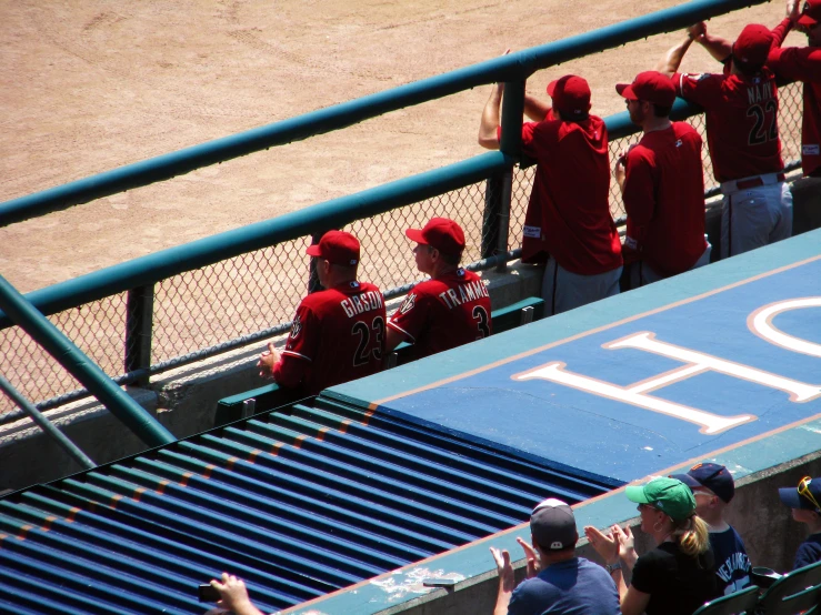 a group of people with red hats stand in front of an athlone bench