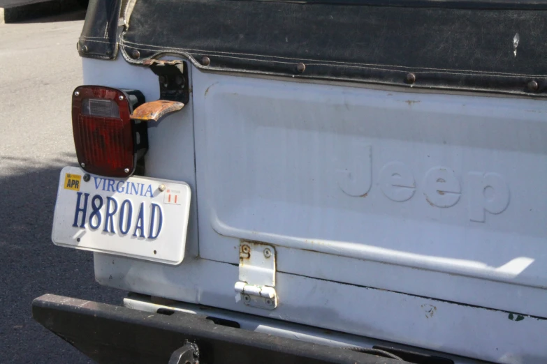 the rear end of an older vehicle parked