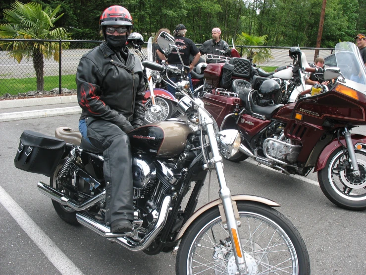 some people are gathered together on motorcycles