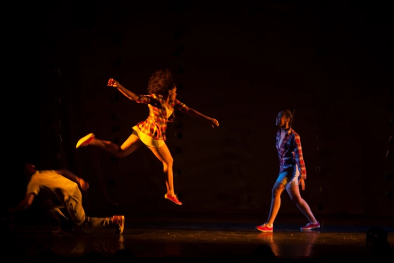 dancers in motion on stage at night