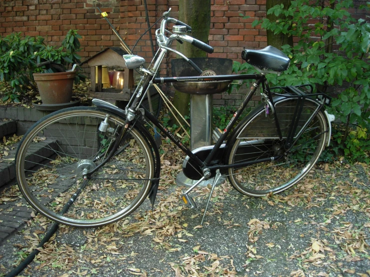 a bicycle parked in the street next to a fire hydrant