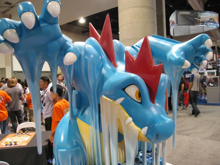 a fake blue and red dragon is in the middle of a booth