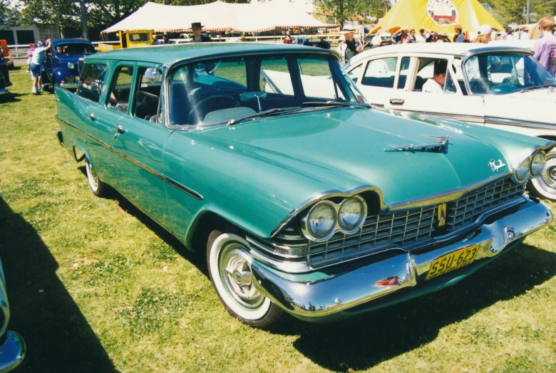 there are some old station wagon cars parked together