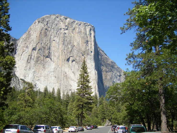 a big very tall mountain next to the trees