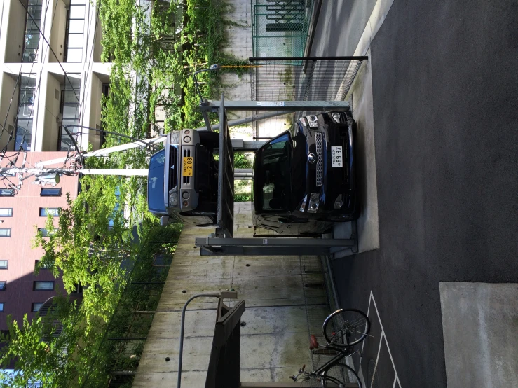 a black car parked inside of a lift