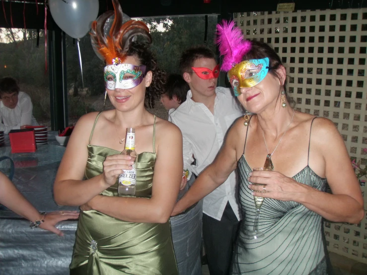 two women are at the party with faces painted in masqueros