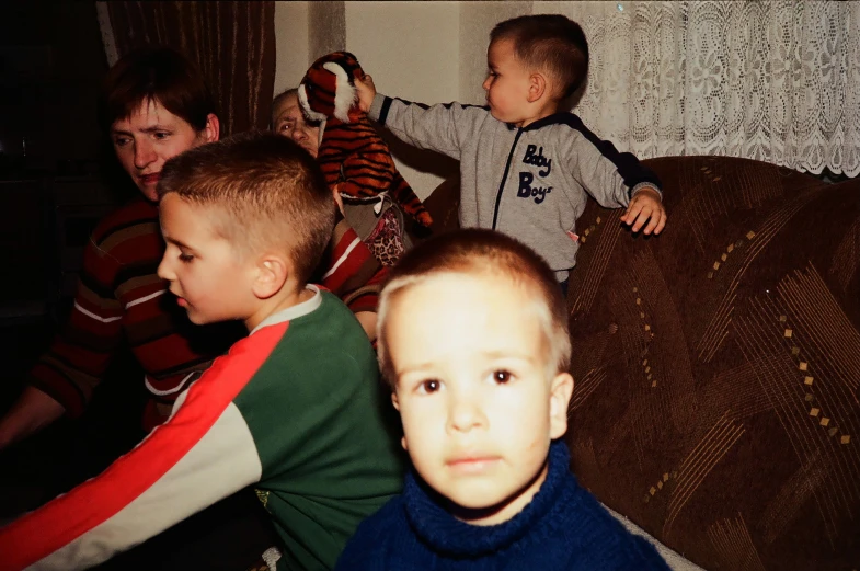 two little boys are playing with each other in a living room