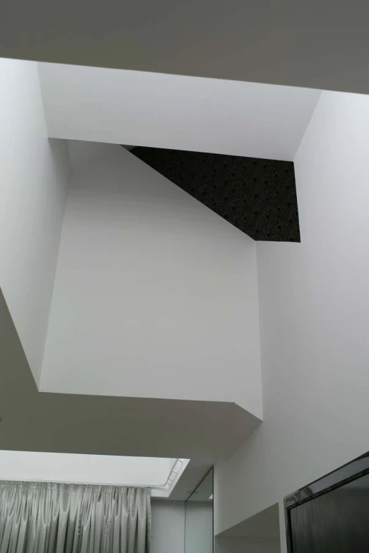a corner shaped ceiling is in white and black