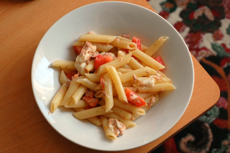 a white bowl with pasta and chicken salad