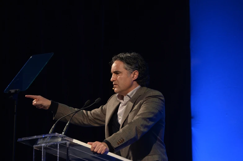 man giving speech to audience at event during daytime