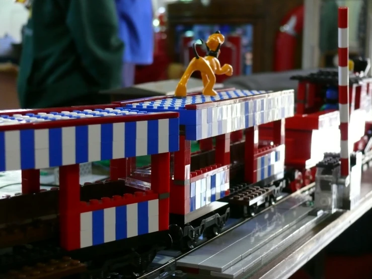 a small lego man is on top of a train