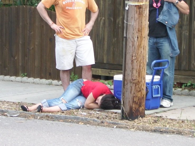 a man and woman standing next to a street pole