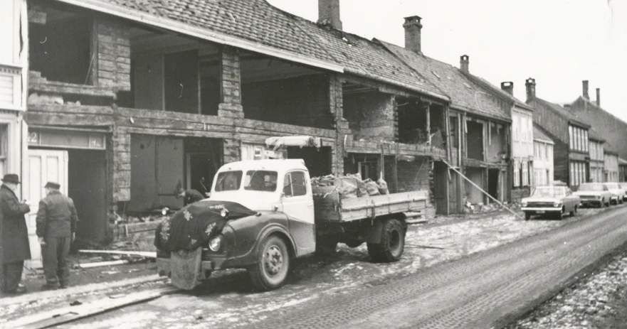 an old pograph of a man in the back of a truck