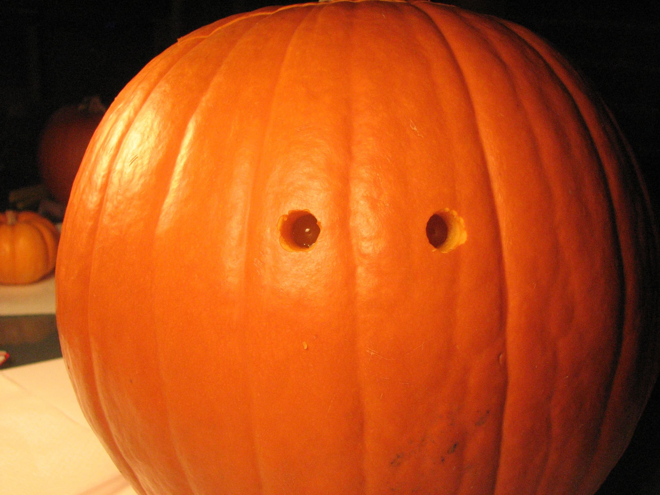 close up of a pumpkin with two holes in the middle