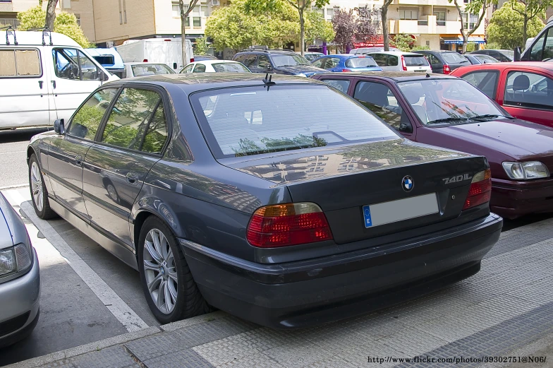 parked bmws lined up in a parking lot in the city