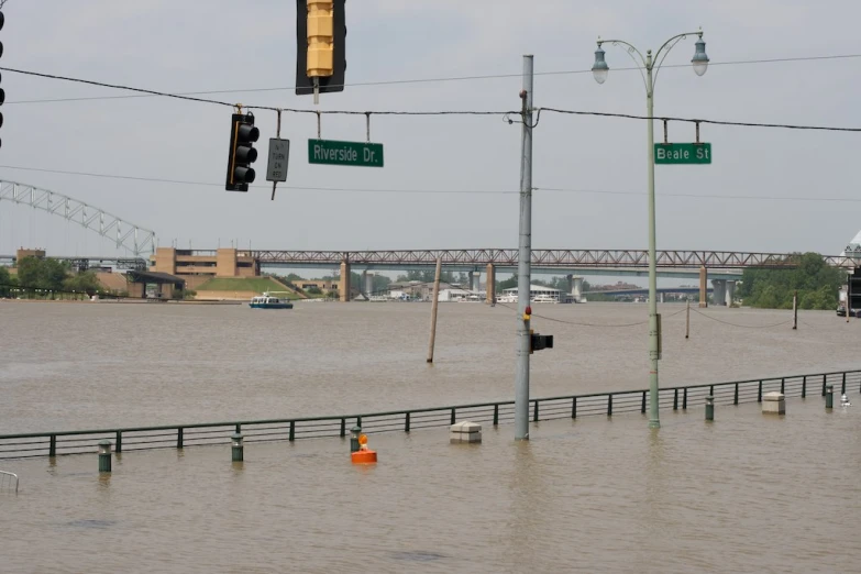 a street sign sitting in the middle of flooded water