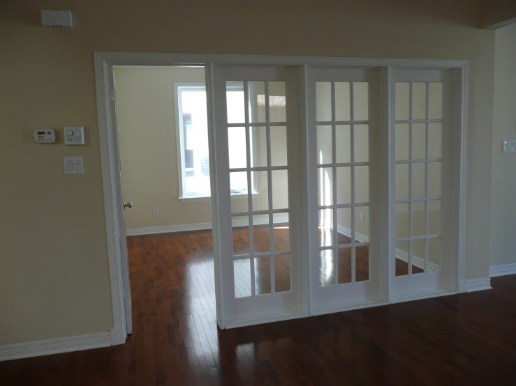 a living room has an open window, hardwood floor and wood floors