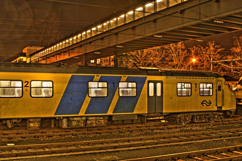 a yellow train that is on the tracks
