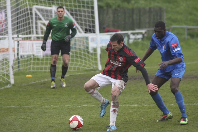 soccer players playing on the field with each other