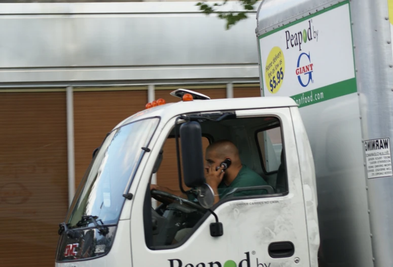 a man on a phone inside a truck