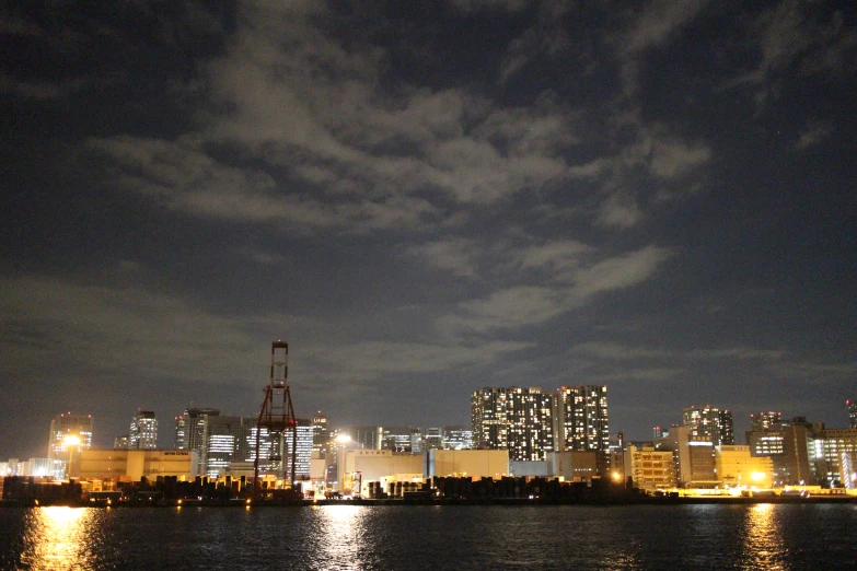 night time over the city of tokyo as seen from across the water