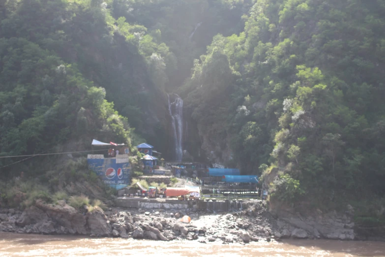 a waterfall and trees are seen in this image