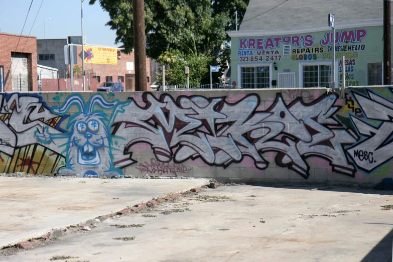 graffiti has been placed on the walls of this skateboard park