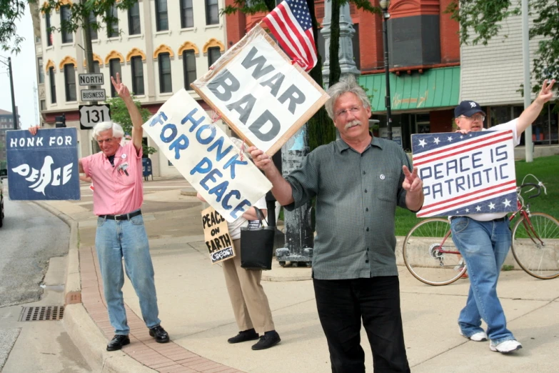 a group of protesters hold signs and signs