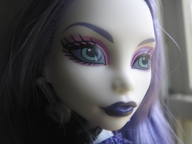 the doll is wearing big blue eyes with bright purple makeup