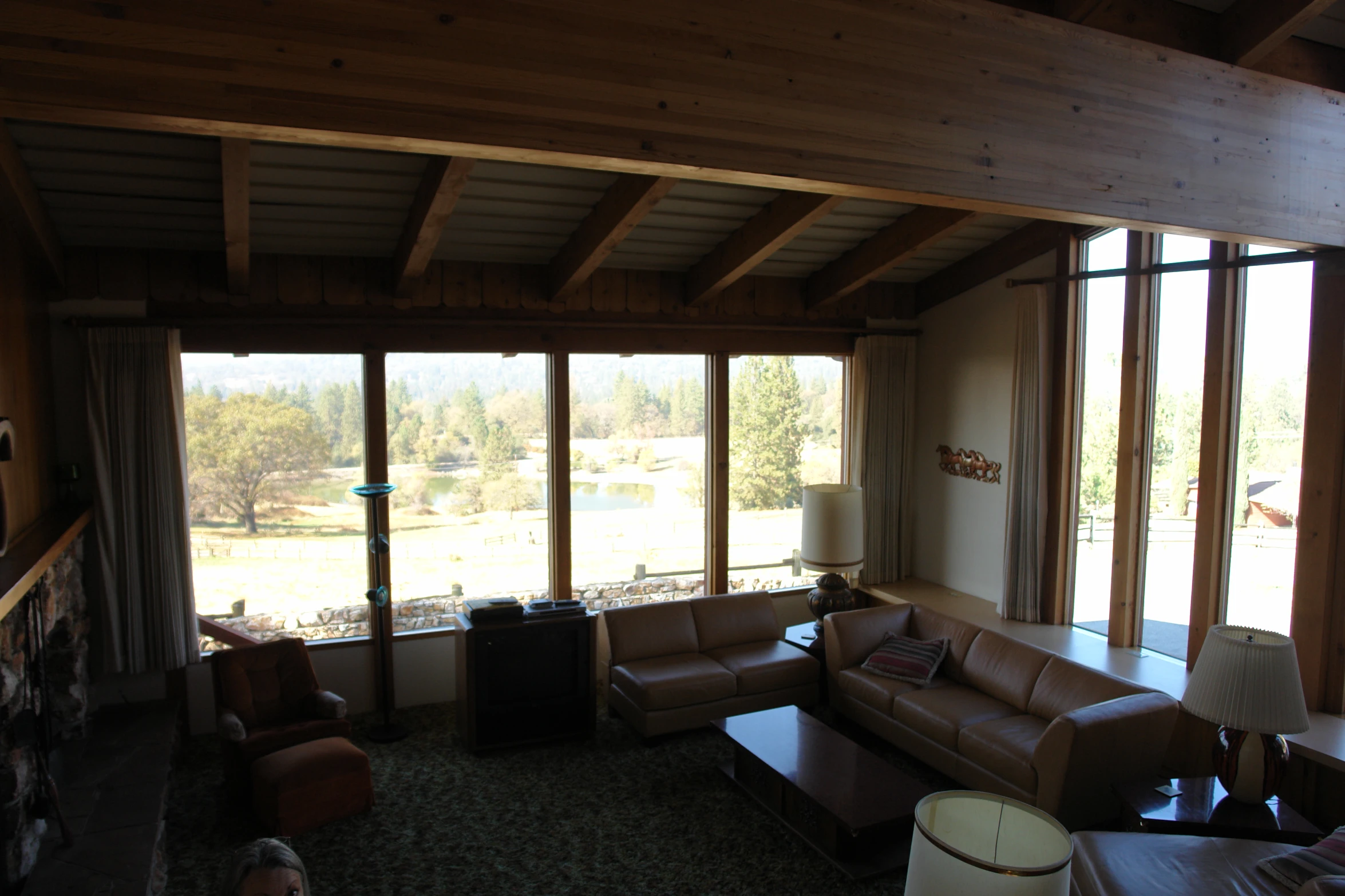 a living room filled with furniture and tall windows