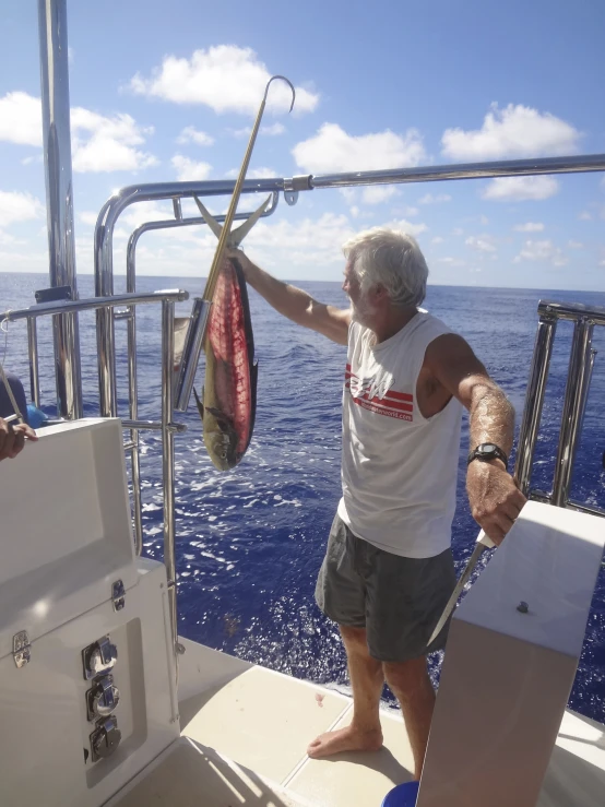 a man holding a flag while standing on top of a boat