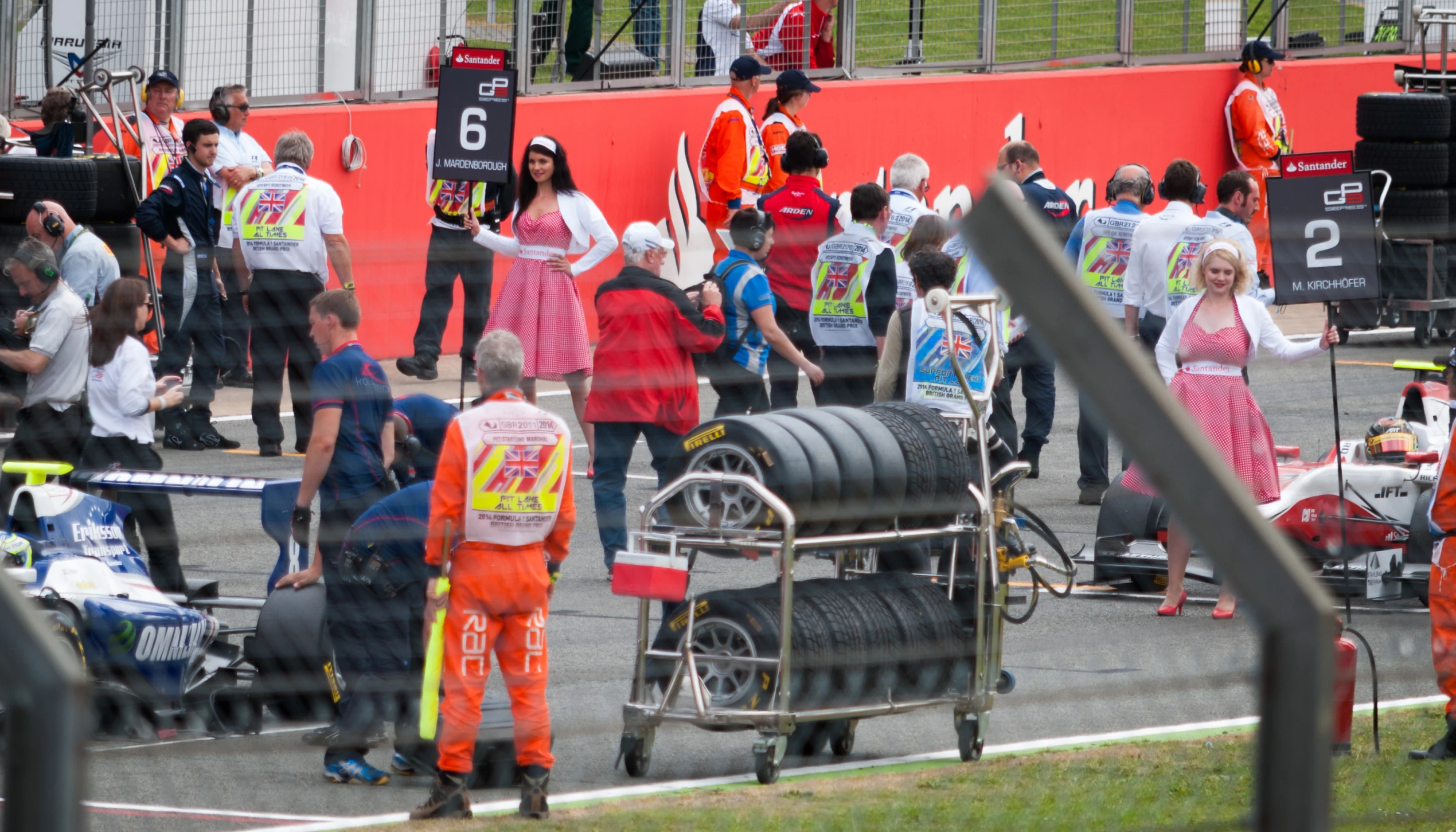 some people wearing orange are watching the race