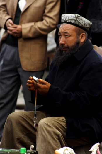 an old man smoking soing in front of two others