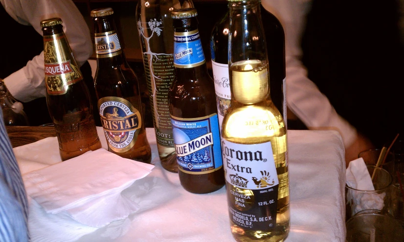 a variety of alcoholic beverages are lined up on a table