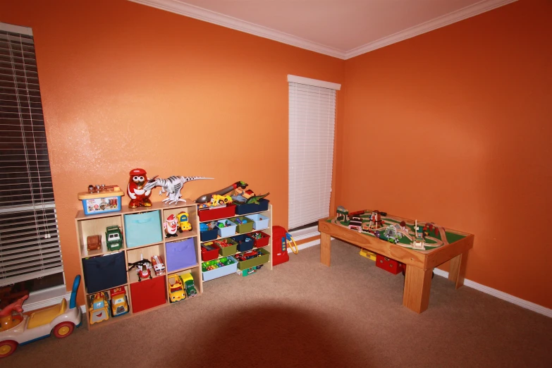 a room is filled with colorful toys in red walls