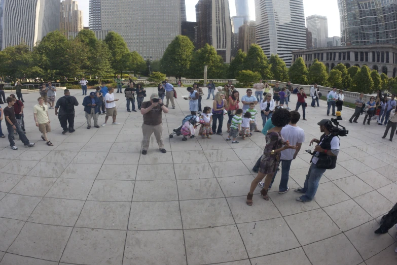 a group of people standing on a circular cement area