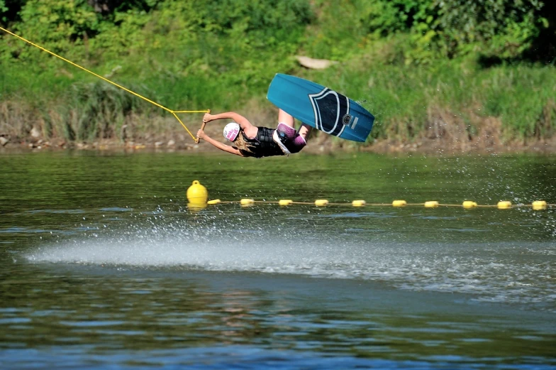 a man flying through the air while riding a wakeboard