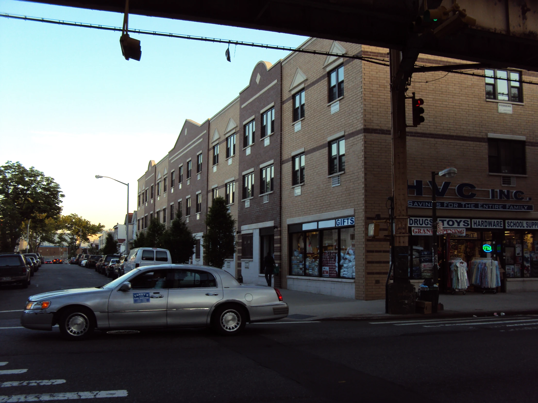 a police car is parked on the street beside a shop