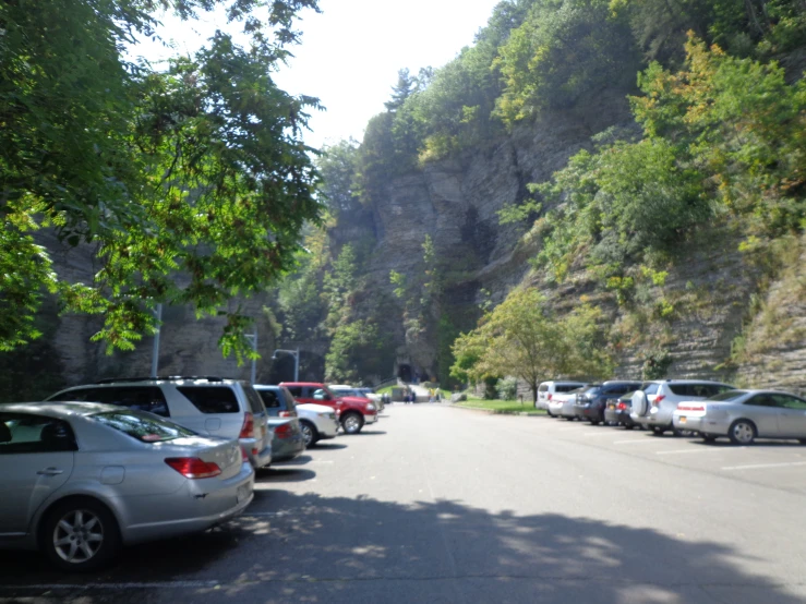 a mountain has some very long cars on the street