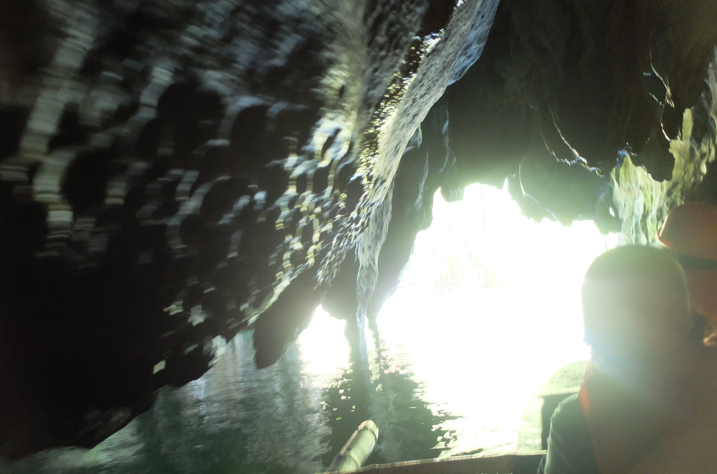 two people on a boat inside a cave