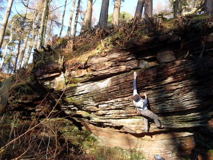 a man doing tricks on a rock face