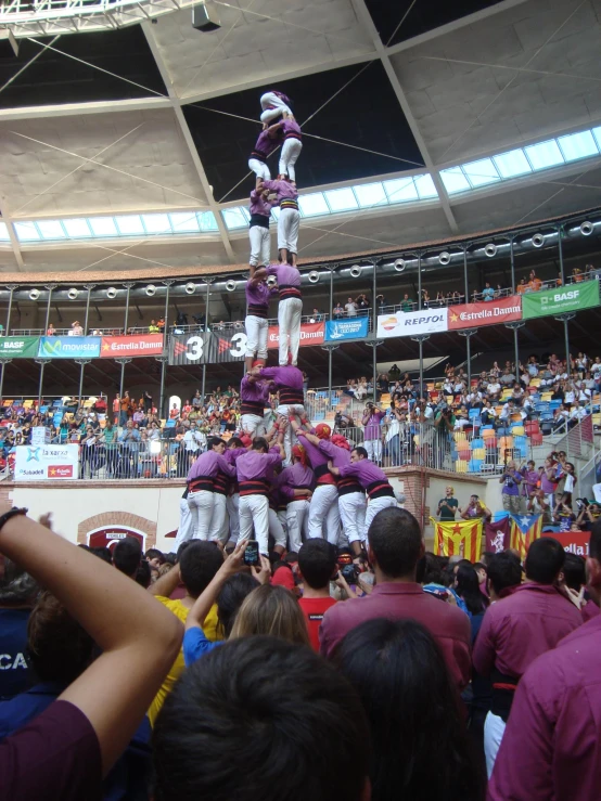 the two men are performing on a huge pillar