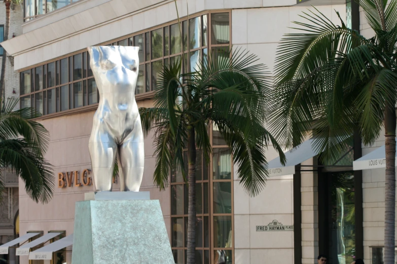 a large statue on a stone base in front of a building