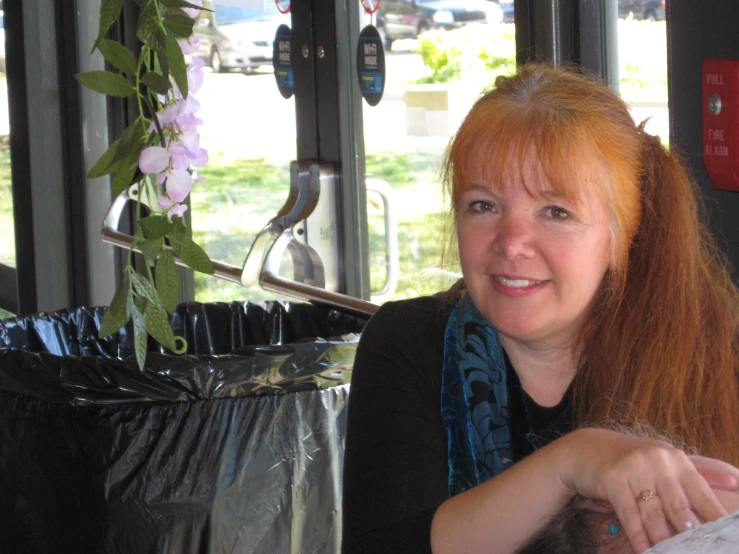 a red haired woman smiles for the camera