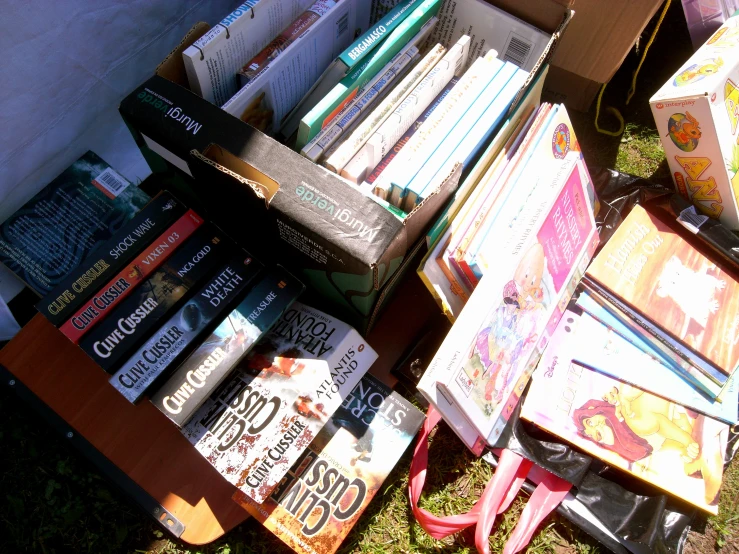 a table filled with lots of books near a box