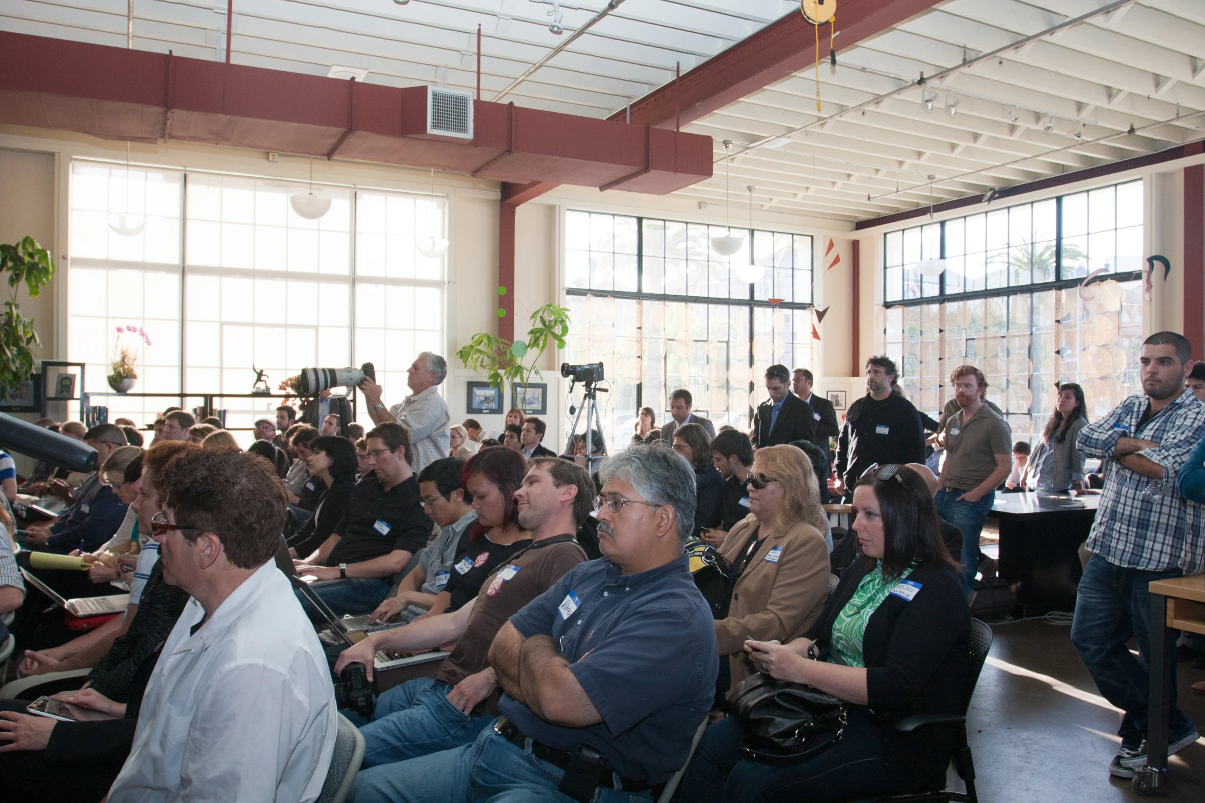 group of people watching people speaking in front of an audience