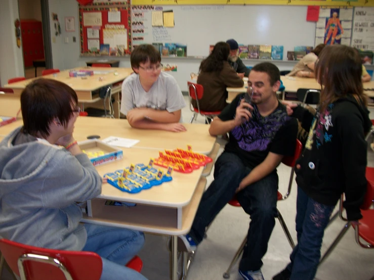 a group of people sitting at a table talking