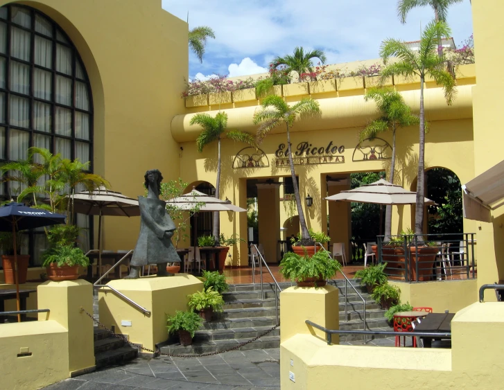 an outdoor restaurant with patio tables and umbrellas