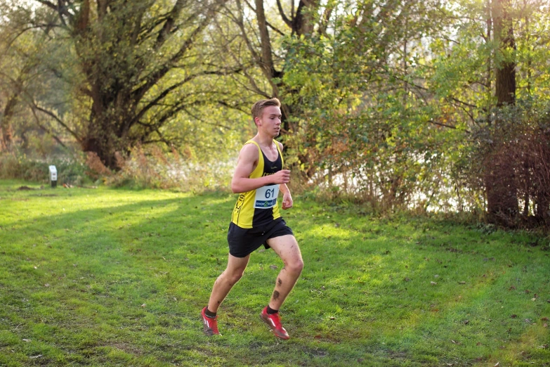 a man in black and yellow running a race