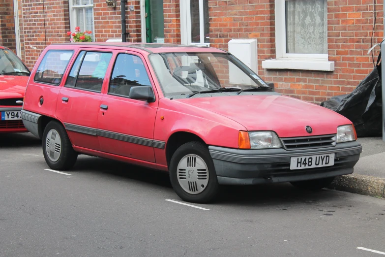 a red station wagon parked on the side of the road